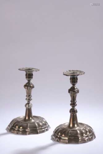 TWO FLAMBEAUX forming a silver pair, each of them …