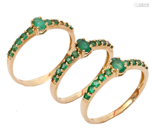 Three modern matching 9ct gold and emerald dress rings, (one stone missing), sizes O-S, gross weight