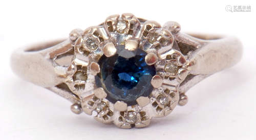 18ct white gold sapphire and diamond cluster ring, the central circular shaped sapphire raised