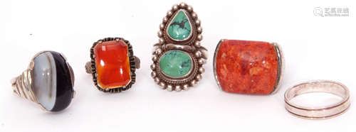 Mixed Lot: four white metal rings, 3 with hardstone designs, one a plain band together with a