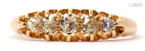 Yellow metal graduated five-stone diamond ring, the 5 old cut diamonds claw set in a carved gallery,