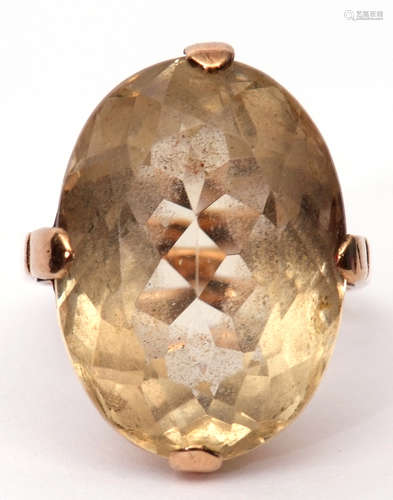 Large Citrine quartz dress ring of oval faceted shape, cardinal set in a plain polished basket