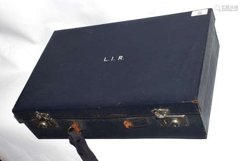 Art Deco travelling case with fitted interior, the top initialled L.I.R., contents include compacts,