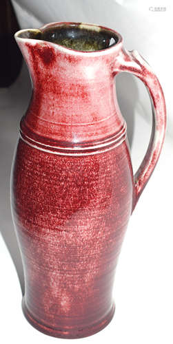 Rouge flambe style jug together with a small Art pottery jug, the largest 31cm high, indistinctly