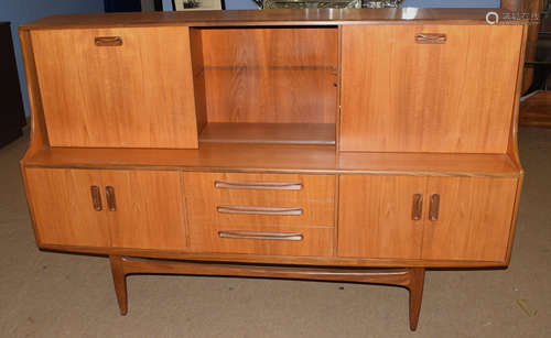 Mid-century teak G-plan sideboard, three drawers to centre, flanked by two twin door cupboards,