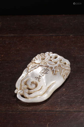 A CONCH BUDDHA’S HAND PLAQUE