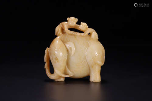 A HETIAN JADE BOYS PLAYING WITH AN ELEPHANT ORNAMENT