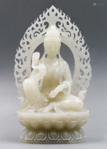 A CHINESE WHITE CRAVED JADE GUANYIN …