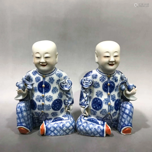 PAIR OF BLUE AND WHITE PORCELAIN BOY S…