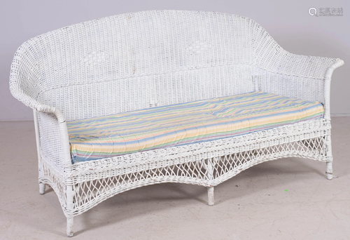 White wicker patio sofa