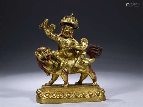 A Chinese Gilded Bronze Statue of Dhammapala Riding A lion