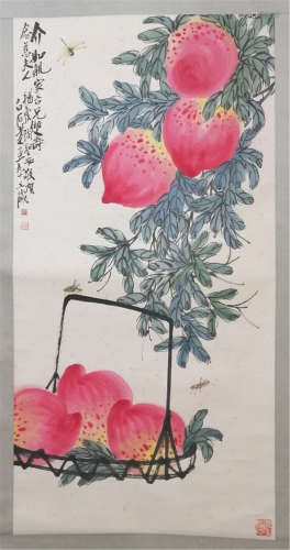 A CHINESE SCROLL PAINTING OF PEACHES WITH CALLIGRAPHY  BY QI BAISHI