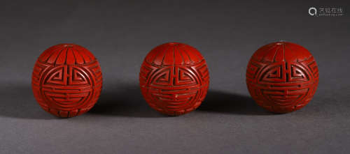 THREE OF CHINESE CINNABAR ENGRAVED WITH SHOU SYMBOL BEADS