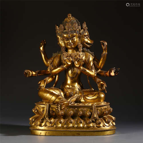 A CHINESE TIBETAN GILT BRONZE CARVED EIGHT ARM SEATED BUDDHIST