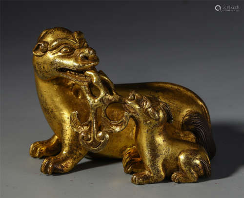 A CHINESE GILT BRONZE CARVED BEAST TABLE ITEM