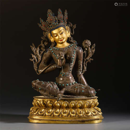 A CHINESE SILVER GILT GEM STONE INLAID GUANYIN ON LOTUS
