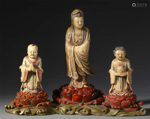 A CHINESE SOAP STOUE CARVED SEATED GUANYIN AND BOYS