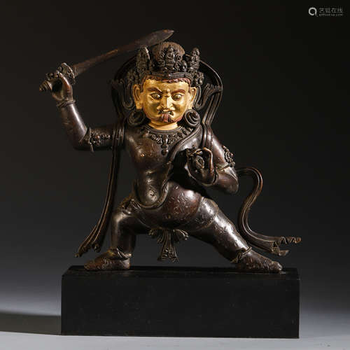 A CHINESE GILT LACQUERED BRONZE BUDDHIST GUARDIAN