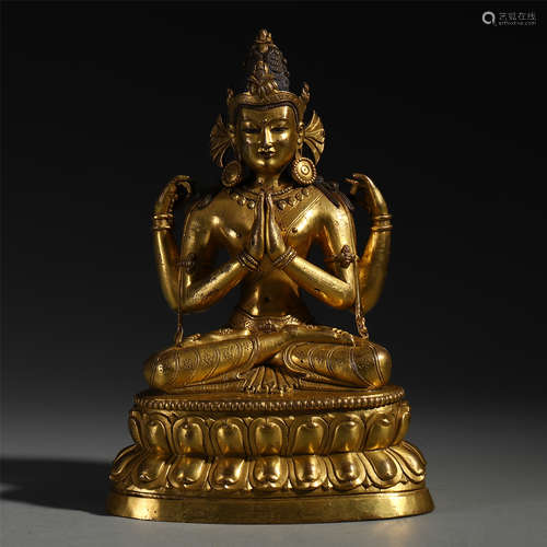 A CHINESE GILT BRONZE FOUR ARM SEATED GUANYIN ON LOTUS