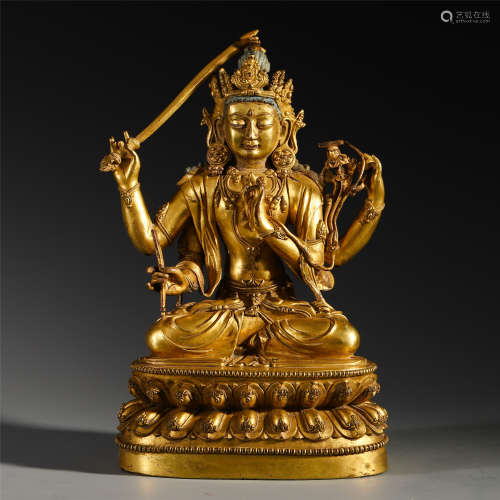 A CHINESE GILT BRONZE FOUR ARM SEATED GUANYIN