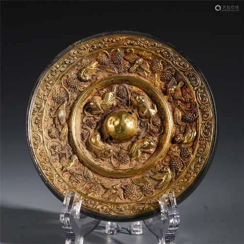 A CHINESE GILT BRONZE CARVED BEAST PATTERN ROUND MIRROR