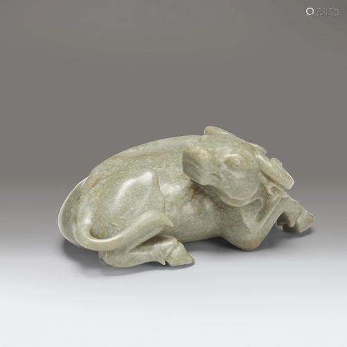 A large Chinese celadon-grey jade buffalo…