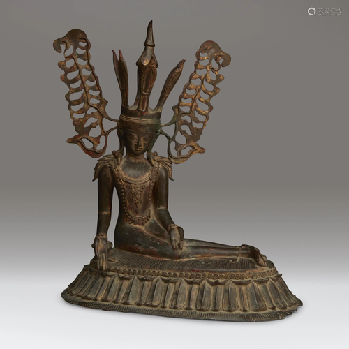 An unusual Burmese bronze figure of a seated