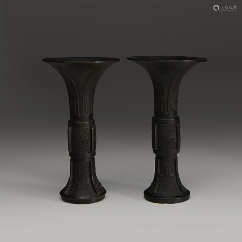 An associated pair of Chinese patinated bronze