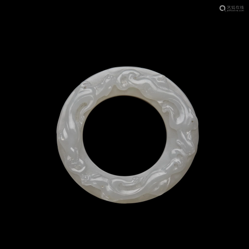 A finely carved Chinese white jade ring,