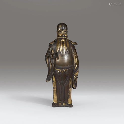 A small Chinese parcel-gilt bronze figure …