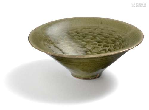 A Chinese Yaozhou bowl decorated with celadon glaze, the interior moulded with four fish and waves. Song-Jin Dynasty. Diam. 10.5 cm. H. 3.5 cm.