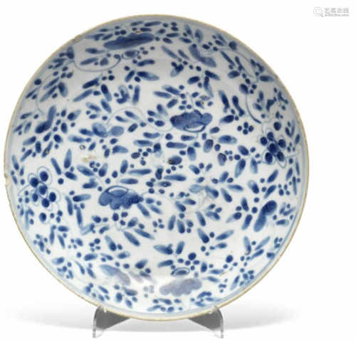 A Chinese Ming porcelain dish decorated in underglaze blue with flowers and foliage. 17th century. Diam 29 cm.