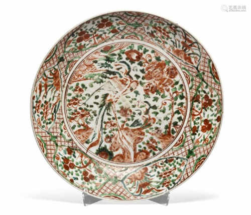 A Swatow porcelain dish decorated in overglaze colours of iron red and green with phoenix bird and flowers. Border in fields with fruits and leaves. Ming.