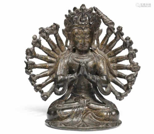 A Sino-Tibetan bronze figure with remains of gilt depicting Avalokitesvara. 16th century. H. 17 cm.