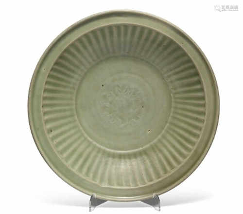 A Chinese longquan celadon dish the centre moulded with a peony surrounded by ribs, rim with slightly raised edge.