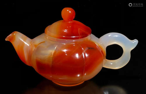 A RED AGATE CARVED TEA POT