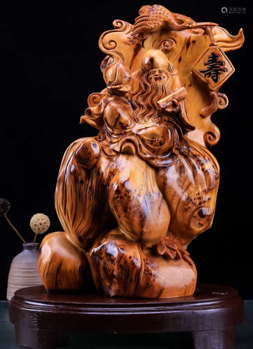 A YABAI WOOD CARVED ELDER SHAPED ORNAMENT