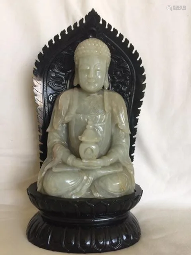 A Celadon Jade Buddha With Dark Green J…