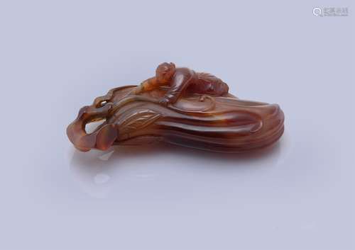 A Chinese carved agate 'Finger citrus and boy' paper weight