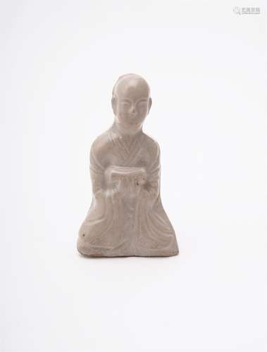 A Chinese press-moulded figure of a seated scholar