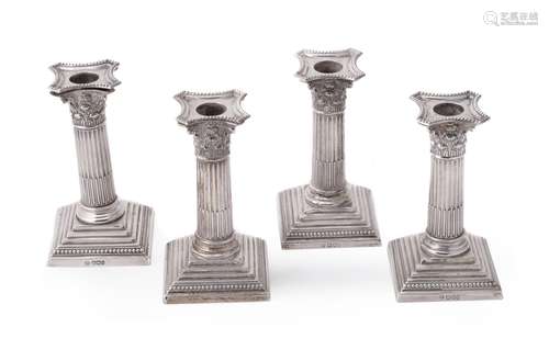 Four late Victorian silver Corinthian candlesticks by William Hutton & Sons Ltd.