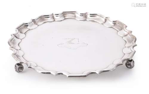 An Edwardian silver shaped circular salver by Thomas Bradbury & Sons