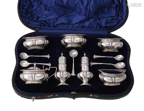 An Edwardian cased silver lobed baluster cruet set by S. W. Smith & Co.