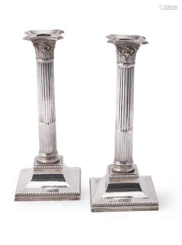 An Edwardian pair of silver Corinthian column candlesticks by Hawksworth, Eyre & Co. Ltd.