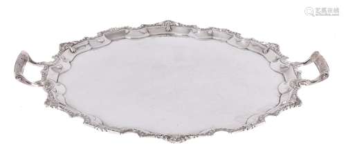 A silver shaped circular twin handled tray by Mappin & Webb