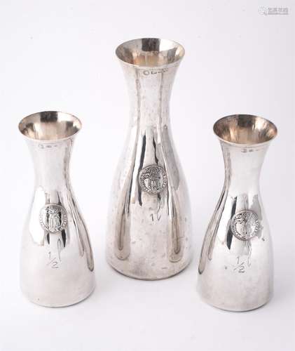 A set of three Italian silver coloured wine carafes by Brandimarte