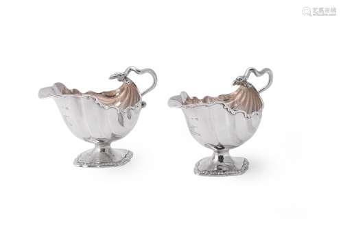 A pair of George III silver shell moulded sauce boats