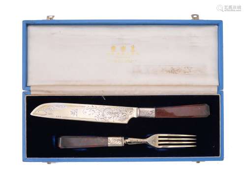 A Victorian silver gilt melon cutting knife and fork by H. J. Lias & Son