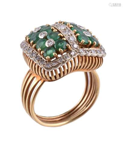 An emerald and diamond cluster ring