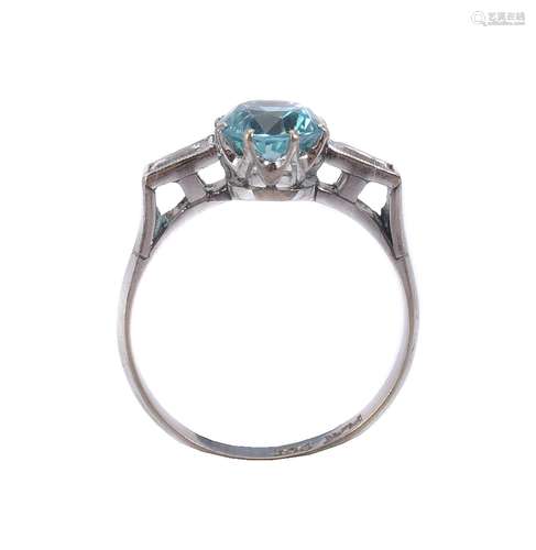 A blue zircon and white stone ring